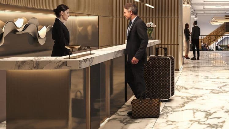 Front-desk team supporting a guest check-in.